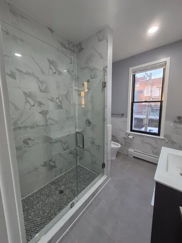 a bathroom with a bathtub and a shower
