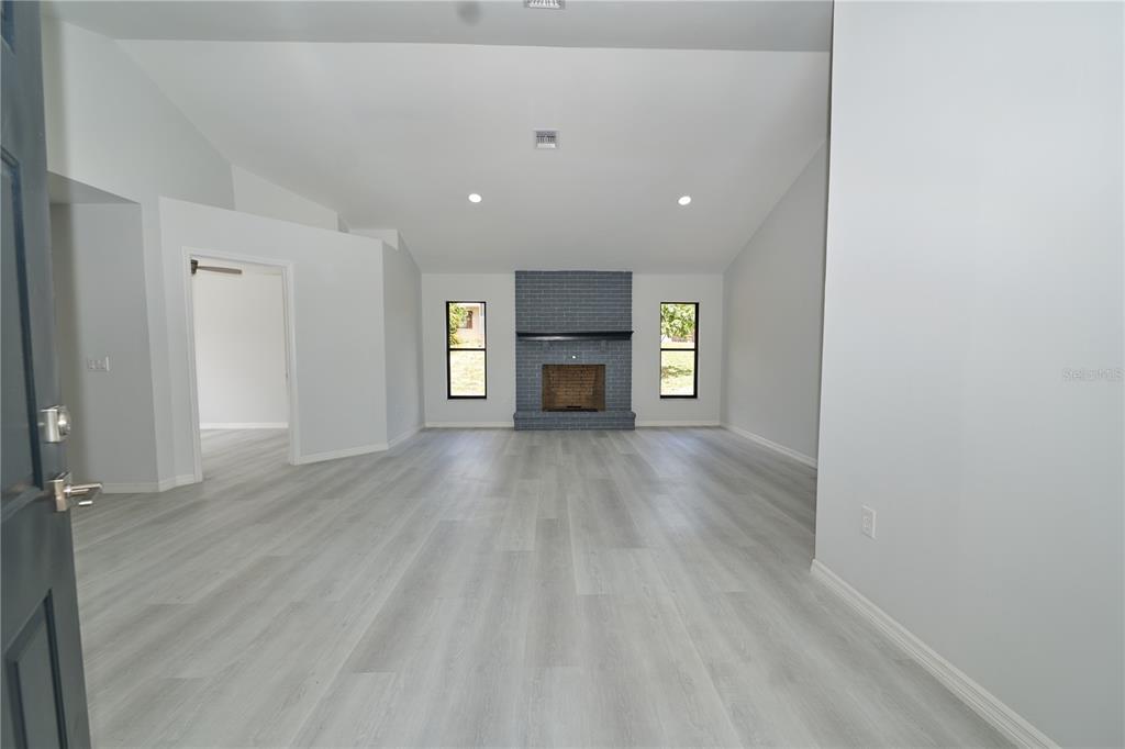 119 Ridgecrest Drive Eustis, FL 32726 - Photo 18 of 52 wooden floor in an empty room with a window