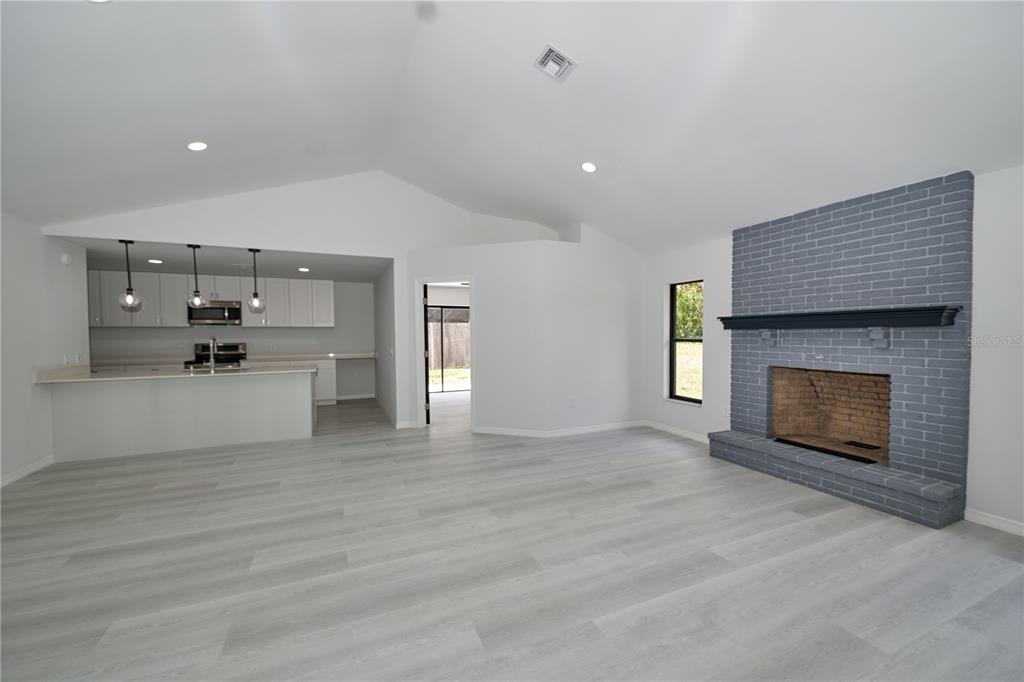 119 Ridgecrest Drive Eustis, FL 32726 - Photo 21 of 52 a view of a kitchen with a sink a fireplace and window