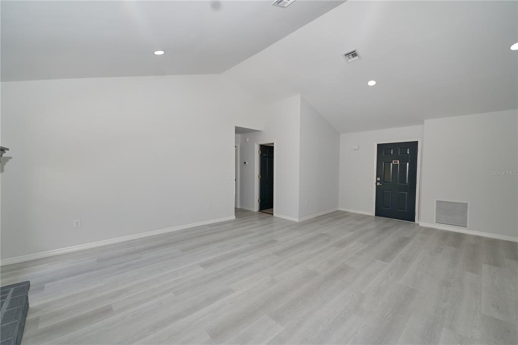 119 Ridgecrest Drive Eustis, FL 32726 - Photo 23 of 52 a view of an empty room with wooden floor and closet