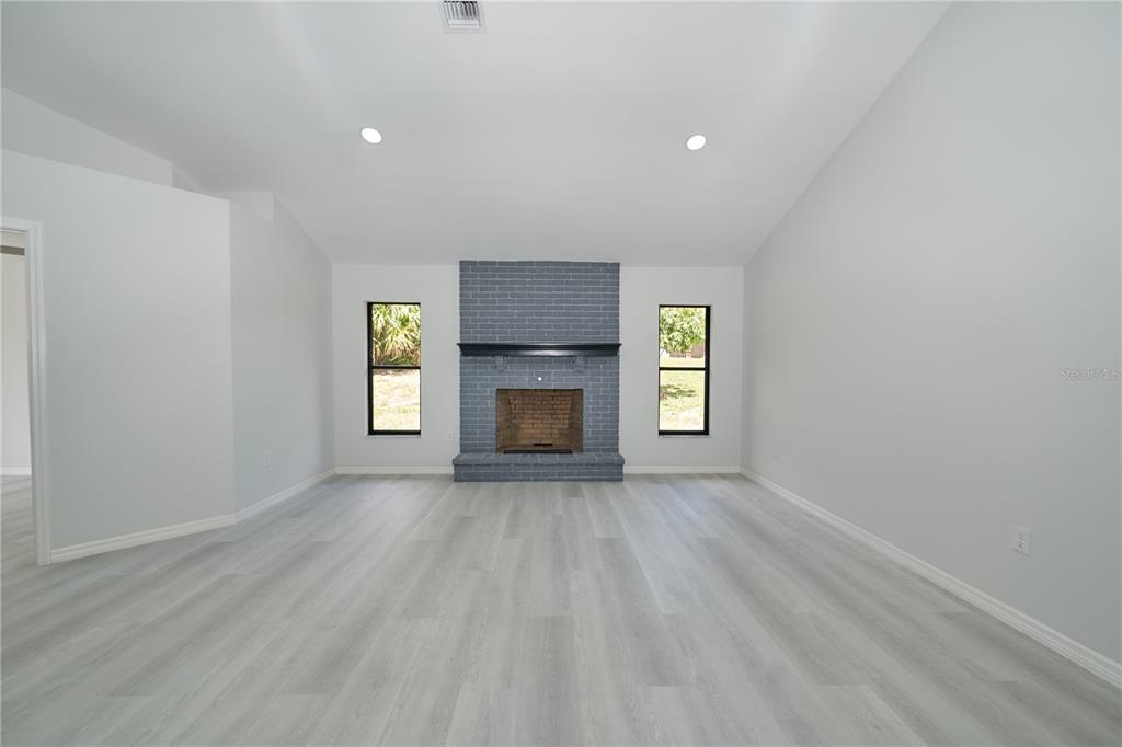 119 Ridgecrest Drive Eustis, FL 32726 - Photo 25 of 52 an empty room with windows and fireplace