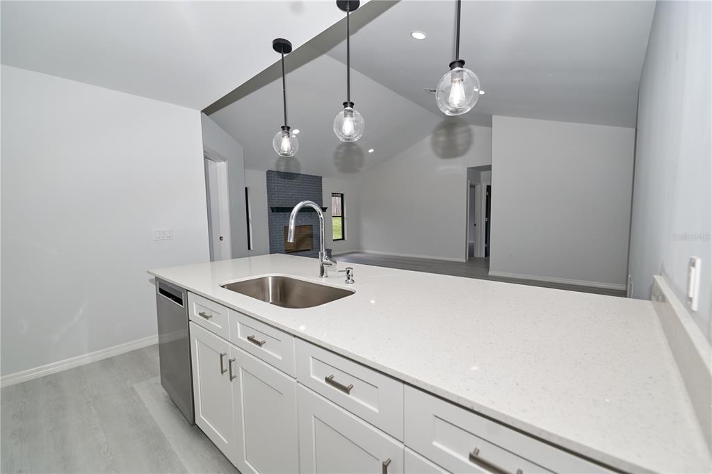 119 Ridgecrest Drive Eustis, FL 32726 - Photo 32 of 52 a kitchen with a sink and chandelier