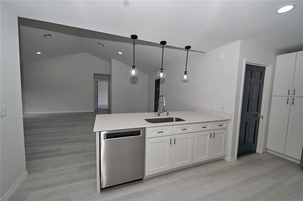 119 Ridgecrest Drive Eustis, FL 32726 - Photo 34 of 52 a kitchen with a sink and a refrigerator