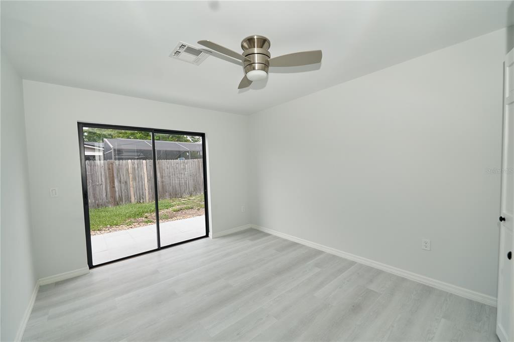 119 Ridgecrest Drive Eustis, FL 32726 - Photo 35 of 52 an empty room with sliding glass door and glass door