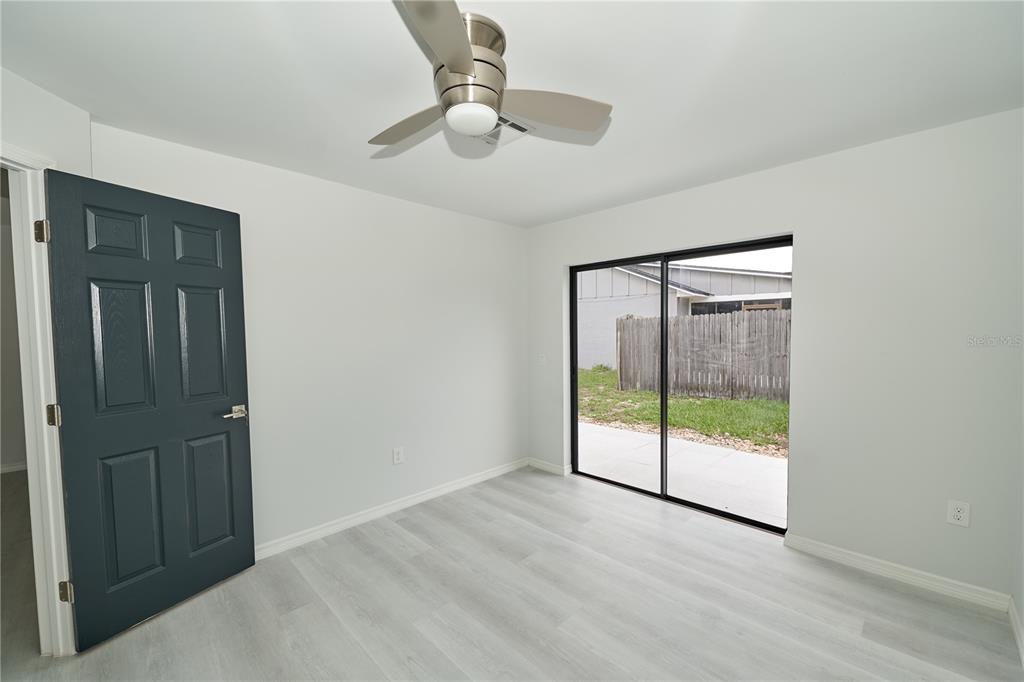 119 Ridgecrest Drive Eustis, FL 32726 - Photo 36 of 52 an empty room with fan and windows