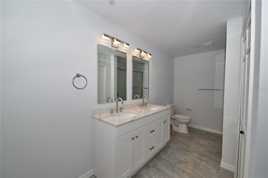 119 Ridgecrest Drive Eustis, FL 32726 - Photo 45 of 52 a bathroom with a double vanity sink toilet and mirror
