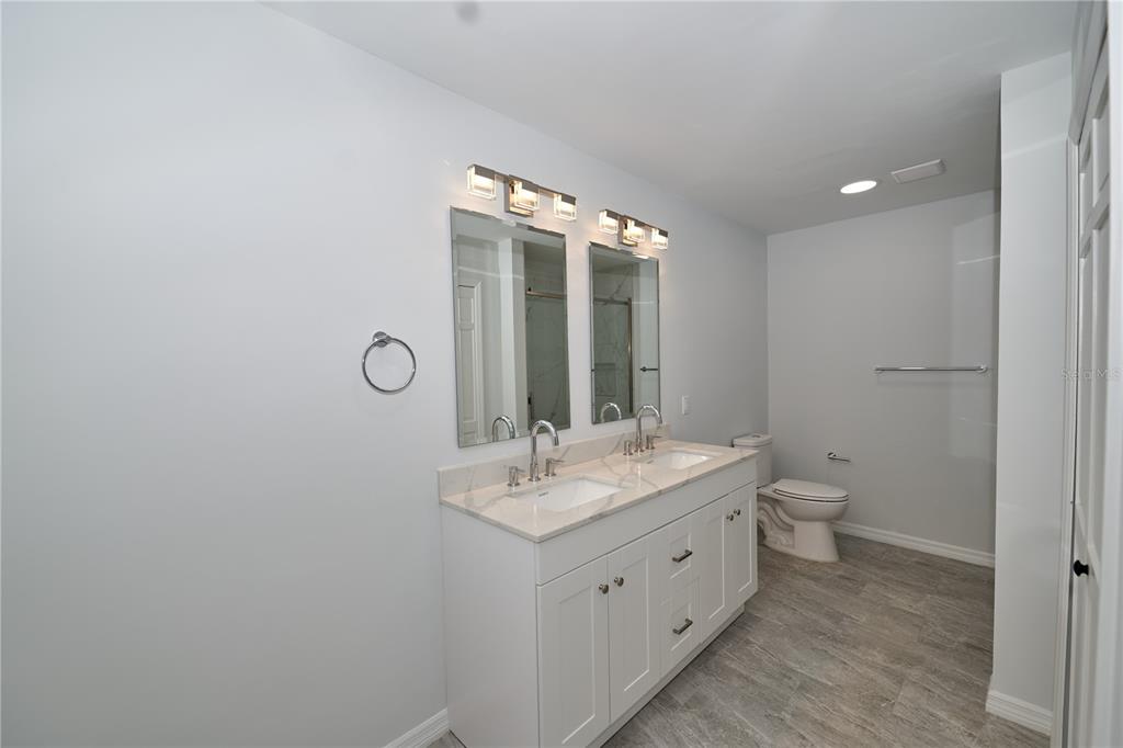 119 Ridgecrest Drive Eustis, FL 32726 - Photo 47 of 52 a bathroom with a double vanity sink and a mirror