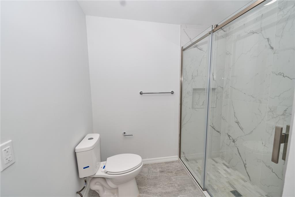119 Ridgecrest Drive Eustis, FL 32726 - Photo 49 of 52 a white toilet sitting next to a shower