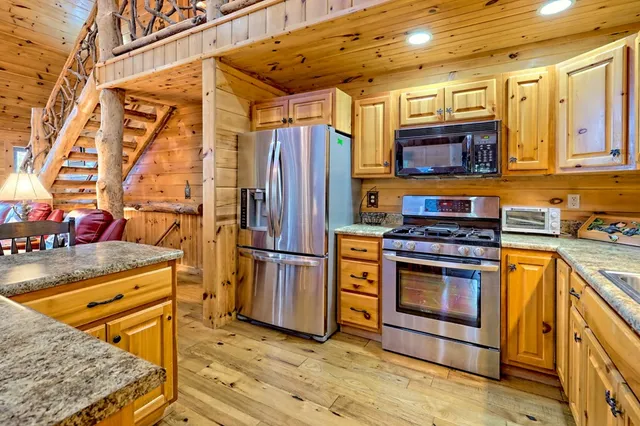 a view of a dining room with furniture a rug and wooden floor