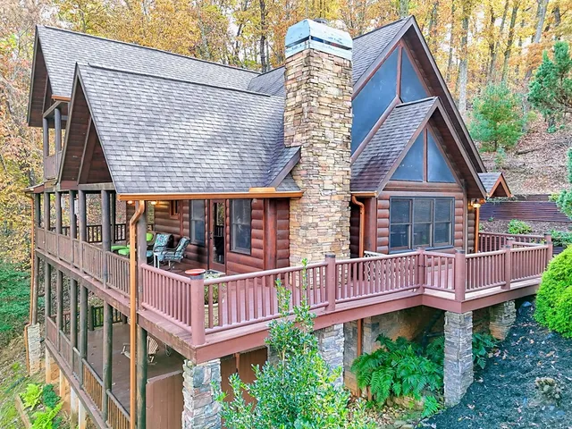 a living room with furniture a fireplace and city view