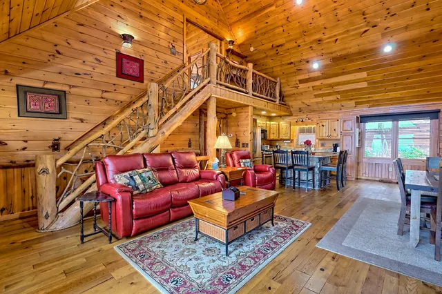 a living room with furniture a fireplace and a table