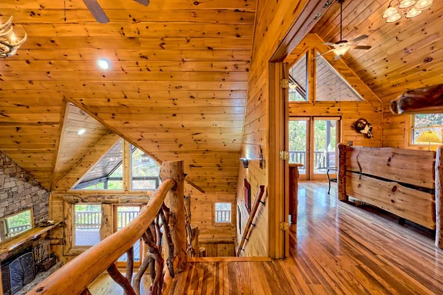 a view of a porch with wooden floor and floor to ceiling window