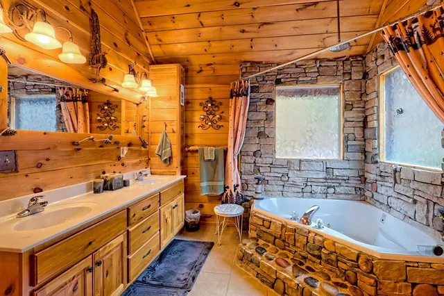 a living room with furniture and floor to ceiling windows