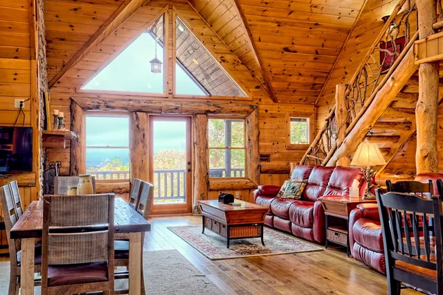 a outdoor living space with furniture a fireplace and a table