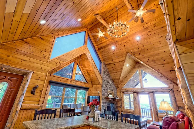 a kitchen with stainless steel appliances kitchen island granite countertop a dining table and chairs