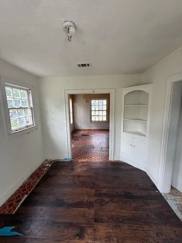 wooden floor in an empty room with a window