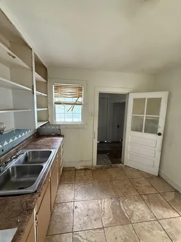 a kitchen that has a sink and a stove
