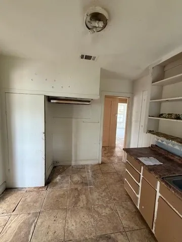 a kitchen with a stove and a refrigerator