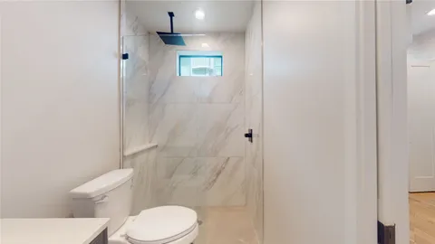 a white toilet sitting next to a shower curtain