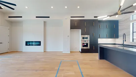 a view of kitchen with stainless steel appliances kitchen island granite countertop a refrigerator and a sink