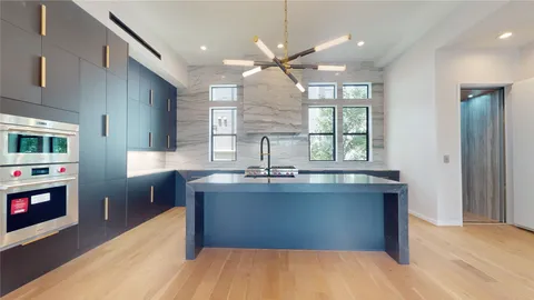 a kitchen with stainless steel appliances granite countertop a sink dishwasher a stove and a refrigerator