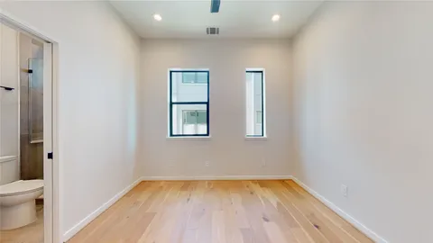a white toilet sitting next to a shower