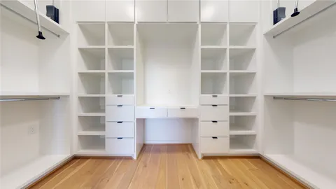 a view of an empty room with window and bathroom