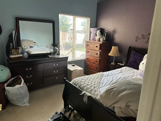 a bedroom with a bed and window