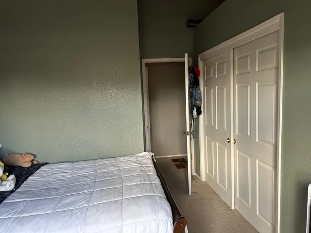 a bedroom with a bed and glass door