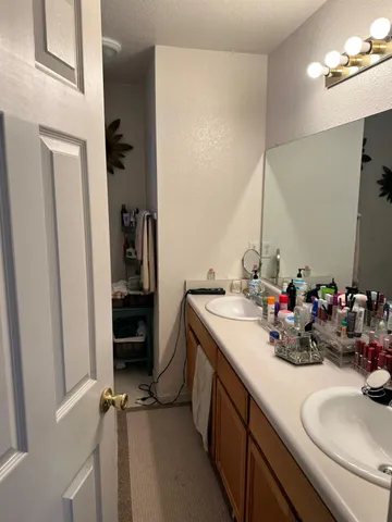 a bathroom with a sink double vanity and a mirror