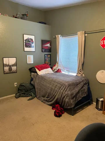 a view of a hallway with wooden floor and a living room