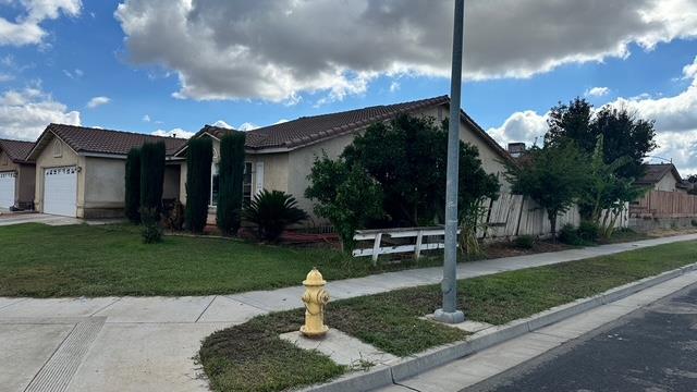 596 St Teresa Street Merced, CA 95341 - Photo 4 of 22 a front view of a house with garden