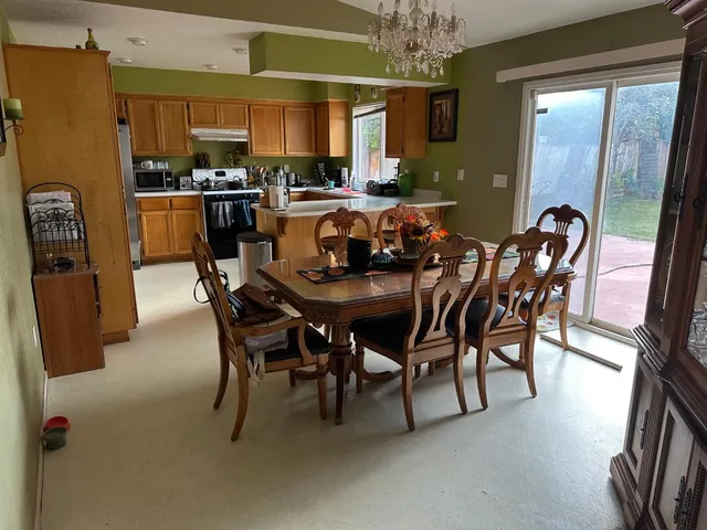 a view of a dining room with furniture and a chandelier
