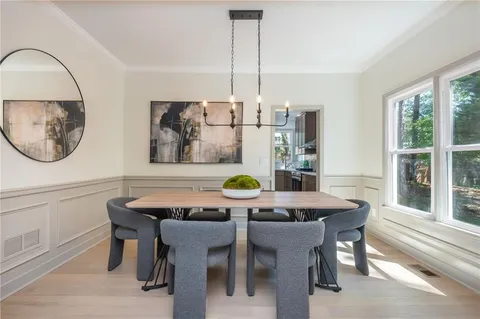 a view of a dining room with furniture and window