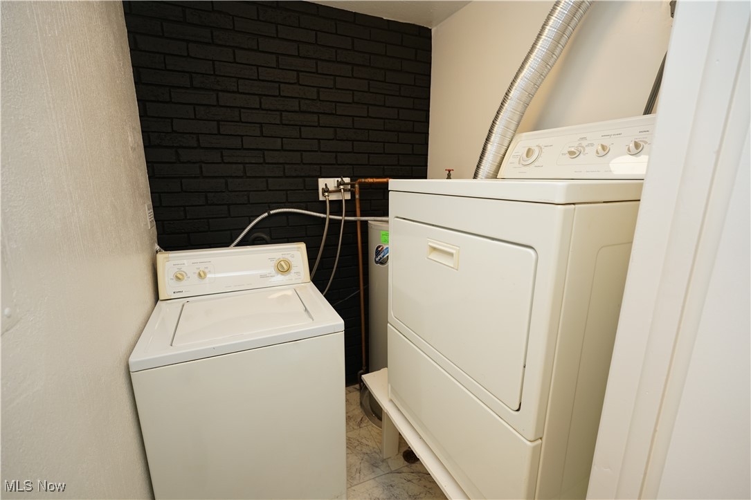 8749 West Ridge Road Elyria, OH 44035 - Photo 14 of 16 Laundry area featuring light marble finish flooring and separate washer and dryer