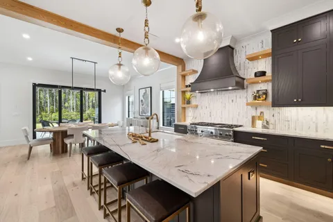 a kitchen with stainless steel appliances granite countertop a stove and a sink