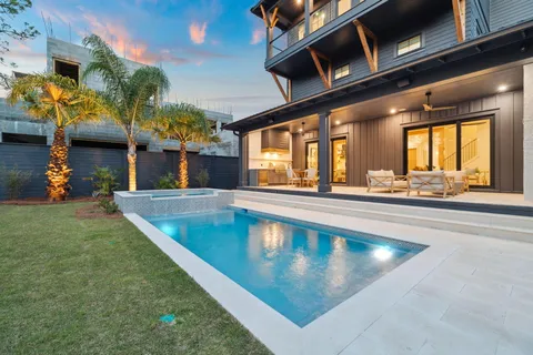 an empty room with windows and ceiling fan