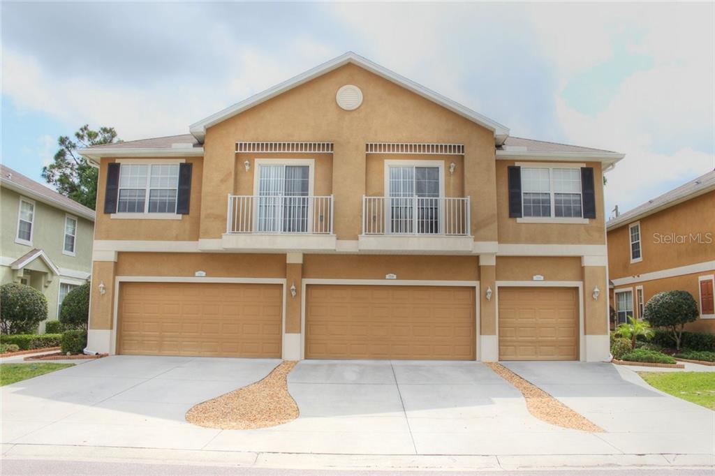 7508 Red Mill Circle New Port Richey, FL 34653 - Photo 1 of 1 a front view of a house with a yard and garage