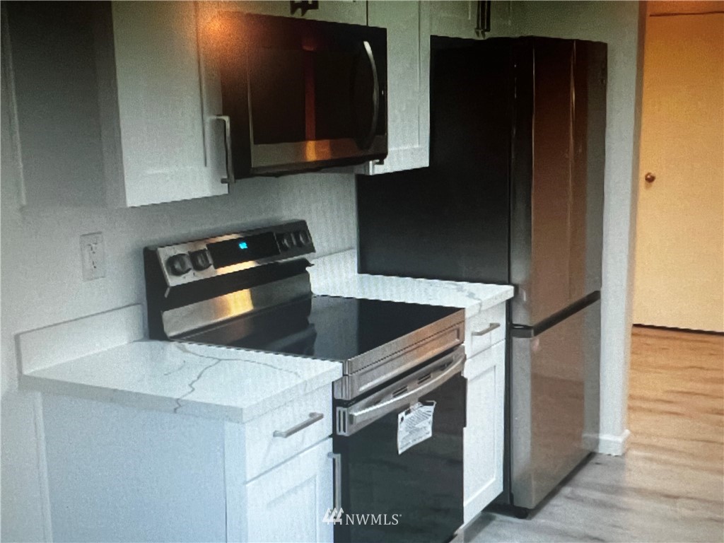 a kitchen with a stove microwave and sink