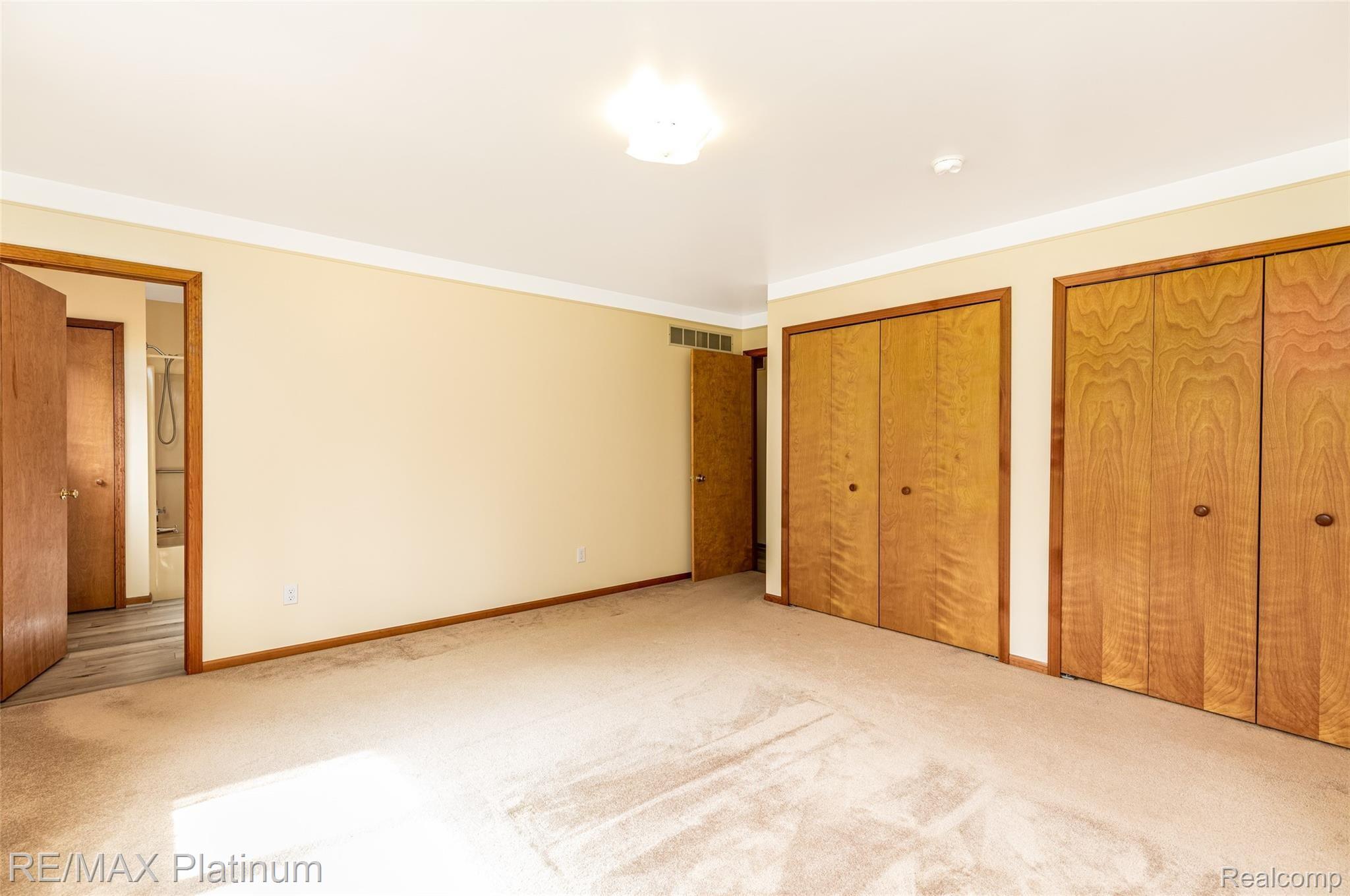 909 Chase Lake Road Howell, MI 48855 - Photo 22 of 37 Two large master closets with the entrance to the Master Bath.