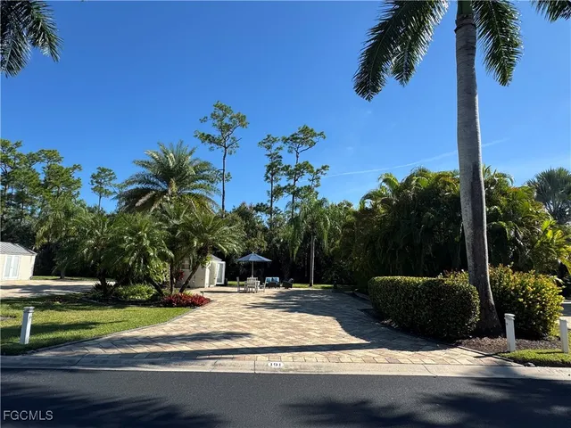 a view of a yard with cars