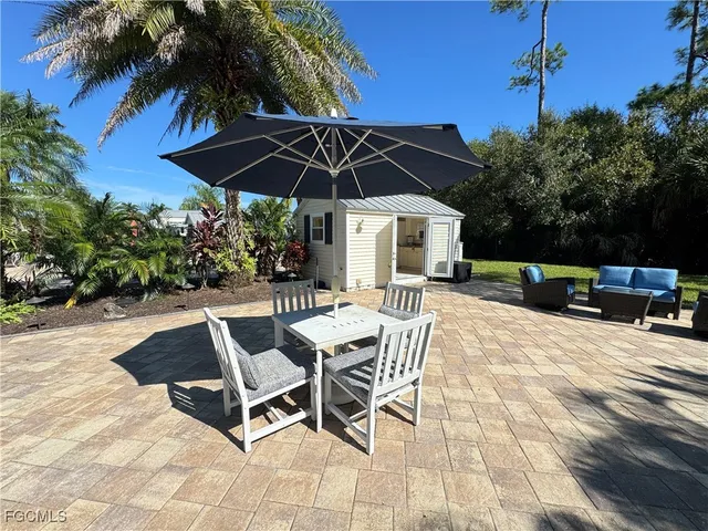 a patio with a patio table and chairs under an umbrella
