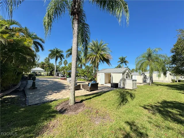 a view of a house with swimming pool and sitting area
