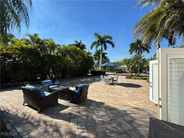 a view of a swimming pool with furniture