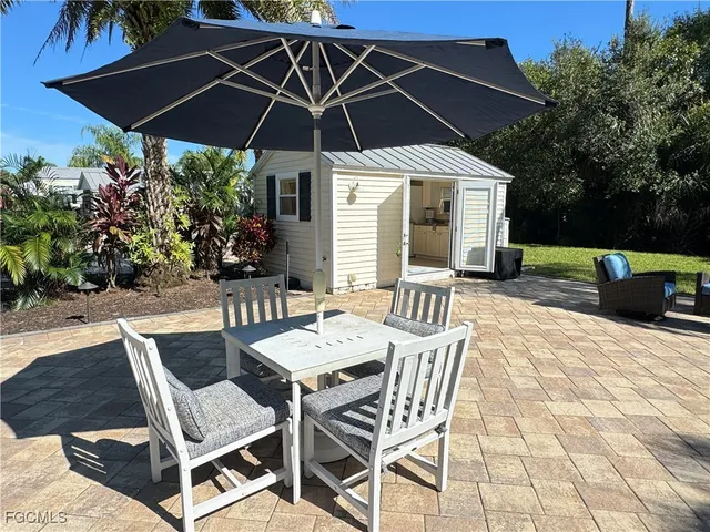 a patio with a patio table and chairs