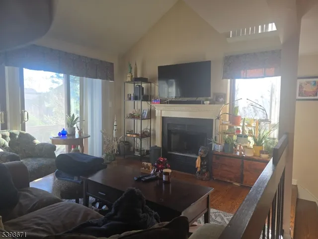 a dining room with furniture a fireplace and large windows