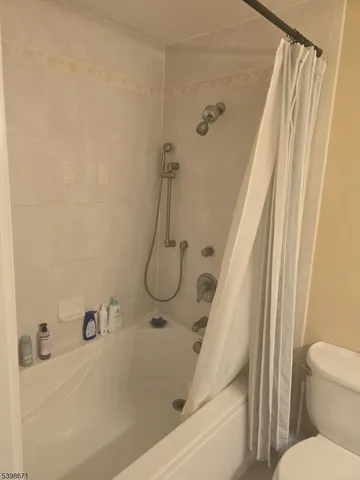 a bathroom with a tub and a shower