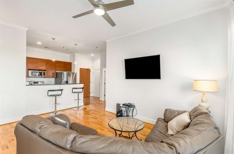 384 Ralph McGill Boulevard Northeast, Unit 313 Atlanta, GA 30312 - Photo 12 of 31 a living room with furniture and a flat screen tv