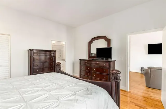 a bedroom with a bed and a large window