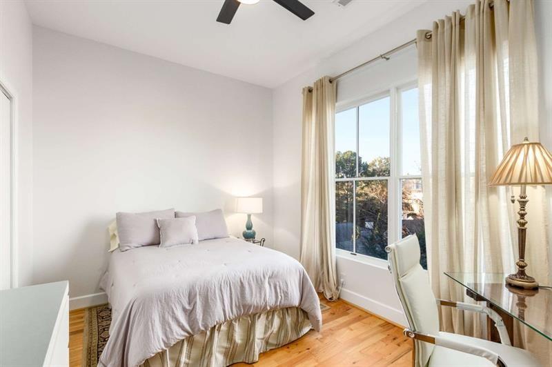 384 Ralph McGill Boulevard Northeast, Unit 313 Atlanta, GA 30312 - Photo 20 of 31 a bedroom with a bed and a large window